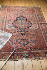 Antique Malayer rug corner detail: madder root red border, stylized florals, tattered fringe.