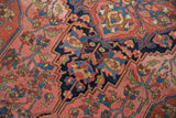 Antique Persian Malayer rug detail: madder root red and deep navy floral pattern with visible abrashes.