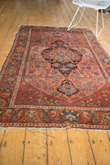 Antique Mission Malayer rug with rich madder red abrashes, intricate floral designs, and tattered edges.