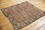 Antique Caucasian rug showcasing geometric borders, crab motifs, and characteristic even pile wear.