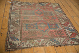 Antique Caucasian rug showing double medallion, crab design, pinwheels, and overall aged wear.