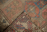 Antique Caucasian rug, circa 1910's, with visible hand-knotted foundation and tattered fringe.