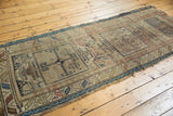 Rectilinear geometric patterns, serrated border, and time-softened hues on this antique Caucasian runner.