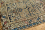 Antique Caucasian runner's worn edge showing serrated leaf border with blue and terracotta motifs.