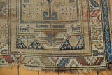 Worn lower corner of antique Caucasian runner; geometric patterns, tattered fringe, ivory, blue, terracotta.