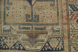 Rectilinear drawing, serrated border, blue and terracotta tones on an antique Caucasian runner.