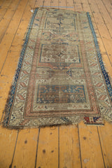 Rectilinear pattern and heavy perimeter wear on antique Caucasian runner's bottom corner.