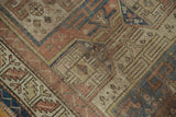 Collector antique Caucasian rug with rectilinear pattern, worn pile, and loss in terracotta, beige, and blue.