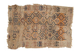 Antique Caucasian fragment rug, multi-medallion pattern, tangerine, blue, faded red, beige, threadbare.