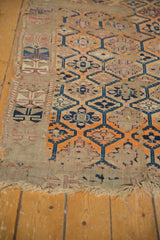 Frayed fringe and threadbare edge of a late 19th-century Caucasian geometric rug.