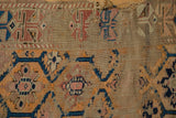 Threadbare texture and exposed foundation with faded geometric motifs on an antique Caucasian rug.