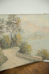 Angled view of Luciani's painting, highlighting winding path, green foliage, and partial artist signature.