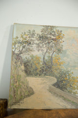 Artist Luciani's signature in the lower left corner of the landscape painting.