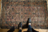 Antique hand knotted Lilihan rug: faded brick field, indigo vinery, and floral motifs.