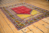 Turkish Melas rug, cherry red prayer niche, saffron yellow field, Ladik panel, and boteh borders.