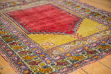 Vintage Melas rug with saffron yellow field, cherry red prayer niche, and boteh borders.