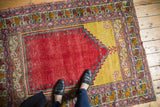 Vintage Melas rug corner with cherry red field, saffron yellow, and Ladik style panels.