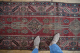 Blush rose border with large-scale serrated leaf motifs on a hand-knotted antique Karabagh runner.