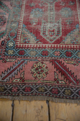 Detail of the serrated leaf border and low, time-softened pile on an antique Karabagh runner.