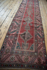 An antique Karabagh runner viewed down its length, highlighting its column of medallions.