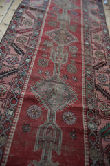 Time-etched texture of the geometric medallion and serrated leaf border on an antique Karabagh runner.