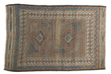 Antique Belouch rug, geometric indigo, madder red, ivory diamond medallions, showing mostly even wear.