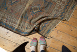 Antique Belouch rug end featuring original plainweave, indigo blue, madder red geometric borders, and worn pile.