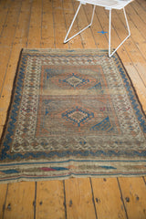 Antique Belouch rug end plainweaves with hard etching in dark brown, black, and indigo blue.