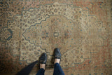 Antique Farahan Sarouk rug displaying intricate floral vinery, medallion, and even pile wear.