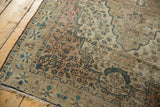 Antique Farahan Sarouk rug corner, intricate vinery, oversized border florals, faded blue.