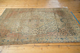Intricate floral main border of the antique Farahan Sarouk rug, showing worn side selvage.
