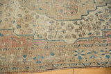 Antique Farahan Sarouk rug border featuring intricate floral motifs and textured, worn pile.