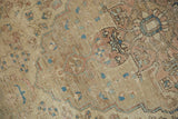 Antique Farahan Sarouk rug, showing intricate faded vinery, floral blossoms, and foundation.