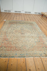 Antique Farahan Sarouk rug end shows light tatter, aged floral border in brick red, dusty blue.