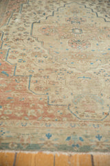Antique Farahan Sarouk rug's intricate floral vinery, showing mostly even wear and visible foundation.