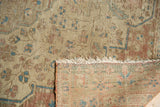 Worn pile of Antique Farahan Sarouk rug with exposed foundation weave and tattered fringe.