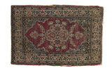 Antique Kerman rug with a scalloped quatrefoil medallion and dense florals on an abrashed fuchsia field.