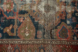 Exposed foundation and faded indigo blue, red, and sage motifs with significant pile loss on an antique Persian Malayer rug.