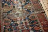 Antique Malayer rug with worn pile revealing foundation, cochineal red and indigo blue Harshang motifs.