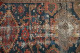 Detail of antique Malayer rug with worn indigo field, Harshang motifs, and foundation loss.