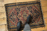 Vintage Hamadan rug central medallion and floral field in navy, brick red, and gold.