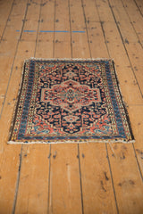 Vintage Hamadan rug corner, showing interlaced navy, brick red border and tattered fringe.