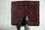 An overhead view showing the scale of a fine antique Hamadan rug with its cherry red field.
