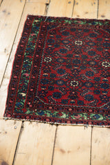 Worn selvedge and corner of an antique Hamadan rug, showing the recessed, brilliant green border.