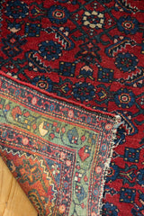 The hand-knotted back of a fine Hamadan rug, highlighting its green border and secure selvage edge.