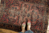 Vintage Lilihan rug featuring low pile, sprawling floral vinery in dusty raspberry and navy.