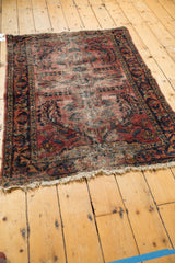 Tattered fringe and low pile of the vintage Lilihan rug, with foundation visible.