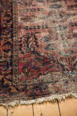 Detail of tattered edge with fresh overcast, showing worn dusty raspberry and navy floral vinery.