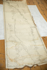 Detail of the vintage nautical map revealing brown water stains and aged paper.