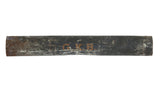 A dark metal ship map tube with a weathered, rusted patina and orange stenciled initials G.K.B.